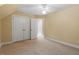 This bedroom features neutral walls and carpet, and a double door closet at 1211 E Pointe Dr, Durham, NC 27712