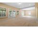 Bonus room features neutral walls and carpet, natural light, and a glass door to the outside at 1211 E Pointe Dr, Durham, NC 27712