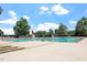 Community pool features multiple lap lanes and lounge seating under a blue sky at 1211 E Pointe Dr, Durham, NC 27712