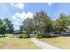 A stone walkway leads to a charming community space with patio seating and a landscaped green at 1211 E Pointe Dr, Durham, NC 27712