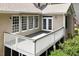 Covered back porch deck with white rails and French doors provides relaxing outdoor living space at 1211 E Pointe Dr, Durham, NC 27712