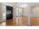 Open entryway featuring hardwood floors, white pillars, large windows, and natural light at 1211 E Pointe Dr, Durham, NC 27712