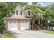 Charming brick and siding home with a two-car garage and beautiful landscaping at 1211 E Pointe Dr, Durham, NC 27712