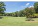 Scenic view of the lush green golf course with tree lined fairways under a blue sky at 1211 E Pointe Dr, Durham, NC 27712