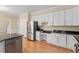Spacious kitchen featuring stainless steel appliances, granite countertops, and ample storage at 1211 E Pointe Dr, Durham, NC 27712
