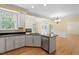 Modern kitchen with stainless steel appliances, granite countertops, and a view of the fireplace at 1211 E Pointe Dr, Durham, NC 27712