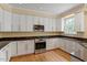 Well-equipped kitchen with stainless steel appliances, granite countertops, and white cabinetry at 1211 E Pointe Dr, Durham, NC 27712