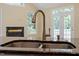 Kitchen sink and faucet with windows, and marble fireplace in the background at 1211 E Pointe Dr, Durham, NC 27712