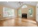 Open living area with large windows, vaulted ceilings, and fireplace at 1211 E Pointe Dr, Durham, NC 27712