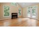 Living room with hardwood floors, fireplace, lots of light from the large windows and french doors at 1211 E Pointe Dr, Durham, NC 27712