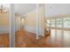 Spacious living room with hardwood floors, large windows, and staircase access at 1211 E Pointe Dr, Durham, NC 27712