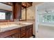 Main bathroom with double vanity, sinks and stone countertops, and walk in shower at 1211 E Pointe Dr, Durham, NC 27712