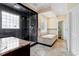 Bright bathroom with separate shower and tub, stone tile flooring and countertops at 1211 E Pointe Dr, Durham, NC 27712