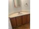 Bathroom vanity featuring a white sink, light countertop, wood cabinets, mirror, and towel ring at 1402 Barton Place Dr, Raleigh, NC 27608
