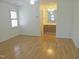 Spacious bedroom featuring hardwood flooring, bright walls, shuttered window, and ensuite bathroom at 1402 Barton Place Dr, Raleigh, NC 27608