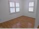 An empty bedroom with neutral walls, hardwood flooring, and white shuttered windows to let in natural light at 1402 Barton Place Dr, Raleigh, NC 27608