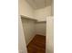 Empty closet with rod for hanging clothes and wood floor in need of organizing at 1402 Barton Place Dr, Raleigh, NC 27608