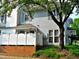 Two-story home with blue siding, black shutters, manicured landscaping, and a brick foundation at 1402 Barton Place Dr, Raleigh, NC 27608