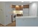 Efficient kitchen with white appliances, wood cabinets, and a functional breakfast bar at 1402 Barton Place Dr, Raleigh, NC 27608