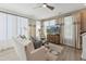 Bright living room featuring neutral decor, large windows, and hardwood style floors for a comfortable and stylish space at 144 N White St # 100, Wake Forest, NC 27587