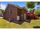 Brick home backyard featuring a deck, manicured lawn, and inviting exterior at 1731 Malone Rd # A, Burlington, NC 27215