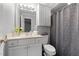 Cozy bathroom with white fixtures, soft lighting, and a patterned shower curtain at 1731 Malone Rd # A, Burlington, NC 27215