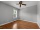 Sunlit bedroom with wood-look flooring, neutral walls and a bright window at 1731 Malone Rd # A, Burlington, NC 27215