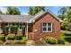 Close-up of a charming brick home featuring a well-kept front yard and an inviting entryway at 1731 Malone Rd # A, Burlington, NC 27215