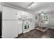 Clean kitchen featuring white cabinets, modern appliances, and a cozy dining area with bright light at 1731 Malone Rd # A, Burlington, NC 27215