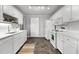 Functional kitchen with white cabinets, modern appliances, laminate floor, and bright lighting at 1731 Malone Rd # A, Burlington, NC 27215
