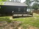 Spacious backyard featuring a wooden deck and an entrance into the home at 1913 Rendall St, Burlington, NC 27215