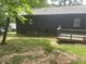View of the backyard featuring a deck and exterior of the home at 1913 Rendall St, Burlington, NC 27215