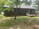 Spacious backyard featuring a wooden deck and a dark-colored home exterior at 1913 Rendall St, Burlington, NC 27215