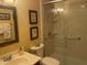 Well-lit bathroom featuring framed bird art, glass enclosed shower, and neutral color palette at 1913 Rendall St, Burlington, NC 27215