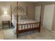 Bright bedroom features a four poster bed, neutral walls, and and closets at 1913 Rendall St, Burlington, NC 27215