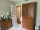 Bedroom features a large armoire, a side table with a lamp, and access to the closets at 1913 Rendall St, Burlington, NC 27215