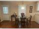 Cozy dining area with a round wooden table and seating for four, next to a bright window at 1913 Rendall St, Burlington, NC 27215