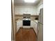 Functional kitchen features white cabinets, appliances, and a clean design for a tidy cooking space at 1913 Rendall St, Burlington, NC 27215