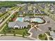 See the community's beautiful pools, clubhouse, manicured landscaping, and nearby homes in this aerial photo at 200 Cloud Berry Ln, Holly Springs, NC 27540