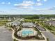 Enjoy this aerial view of neighborhood pool and recreation area with clubhouse and playground at 200 Cloud Berry Ln, Holly Springs, NC 27540