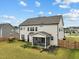 Back exterior of two-story house with fenced in yard, and small flower gardens at 200 Cloud Berry Ln, Holly Springs, NC 27540