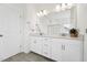 Bright bathroom featuring a double vanity, granite countertops, and tile flooring at 200 Cloud Berry Ln, Holly Springs, NC 27540