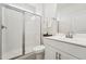 Bright bathroom featuring tile floors, glass enclosed shower, vanity, and chrome fixtures at 200 Cloud Berry Ln, Holly Springs, NC 27540