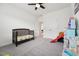 Bedroom with a crib, play area, and plush carpeting at 200 Cloud Berry Ln, Holly Springs, NC 27540
