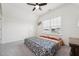 A bright bedroom with ceiling fan, carpeted floors and a large window at 200 Cloud Berry Ln, Holly Springs, NC 27540