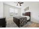 Comfortable bedroom featuring neutral paint, ceiling fan, and a large window for natural light at 200 Cloud Berry Ln, Holly Springs, NC 27540
