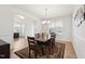 Formal dining room with a large table, elegant chandelier, and views into other rooms at 200 Cloud Berry Ln, Holly Springs, NC 27540