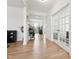 Bright entryway featuring hardwood floors, decorative glass on the front door, and french doors to the living room at 200 Cloud Berry Ln, Holly Springs, NC 27540