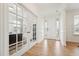 Bright entryway featuring hardwood floors, decorative glass on the front door, and french doors to an office at 200 Cloud Berry Ln, Holly Springs, NC 27540