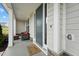 Inviting front porch with a cozy seating area and stylish welcome mat, enhancing curb appeal at 200 Cloud Berry Ln, Holly Springs, NC 27540